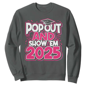 Funny Pop Out And Show Em 2025 Sweatshirt Pink Senior Class Of 2025 Graduation TS11 Dark Heather Print Your Wear