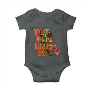 They Not Like Us Afro Queen Baby Onesie Melanin Magic Woman witth Headwrap and Sunglasses TS02 Dark Heather Print Your Wear