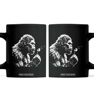 Bigfoot Blowing Dandelion Flower Graphic Coffee Mug Whimsical Sasquatch Profile Artistic Vintage Distressed TS02 Black Print Your Wear