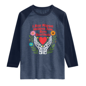 I Hear Migrant Children Also Have Heartbeats Raglan Shirt Groovy Retro Floral Hands Heart Social Justice
