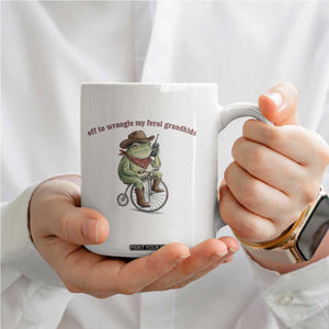 Off to Wrangle My Feral Grandkids Coffee Mug Funny Cowboy Frog Grandpa Western Meme TS14 Print Your Wear