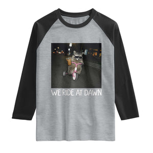 We Ride at Dawn Raglan Shirt Funny Racoon Riding Tricycle Chaotic Meme