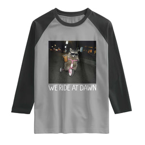 We Ride at Dawn Raglan Shirt Funny Racoon Riding Tricycle Chaotic Meme