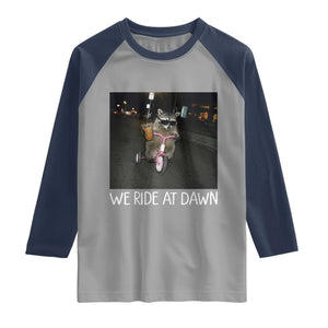We Ride at Dawn Raglan Shirt Funny Racoon Riding Tricycle Chaotic Meme