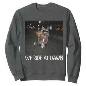 We Ride at Dawn Sweatshirt Funny Racoon Riding Tricycle Chaotic Meme