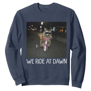 We Ride at Dawn Sweatshirt Funny Racoon Riding Tricycle Chaotic Meme