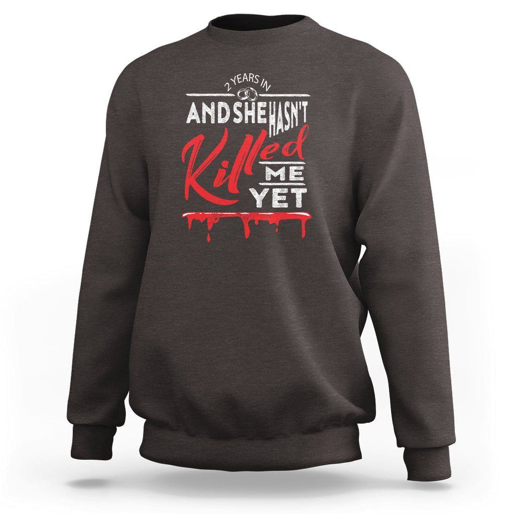 2nd Wedding Anniversary Sweatshirt 2 Years And She Hasn't Killed Me Yet Marriage Couple Matching TS09 Dark Chocolate Printyourwear