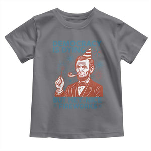 Funny 4th of July Satire Toddler T Shirt Democracy Is Dying But Hey Nice Fireworks Abe Lincoln TS02 Charcoal Print Your Wear
