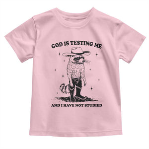 Funny God Is Testing Me And I Have Not Studied Toddler T Shirt Cowboy Racoon TS11 Light Pink Print Your Wear