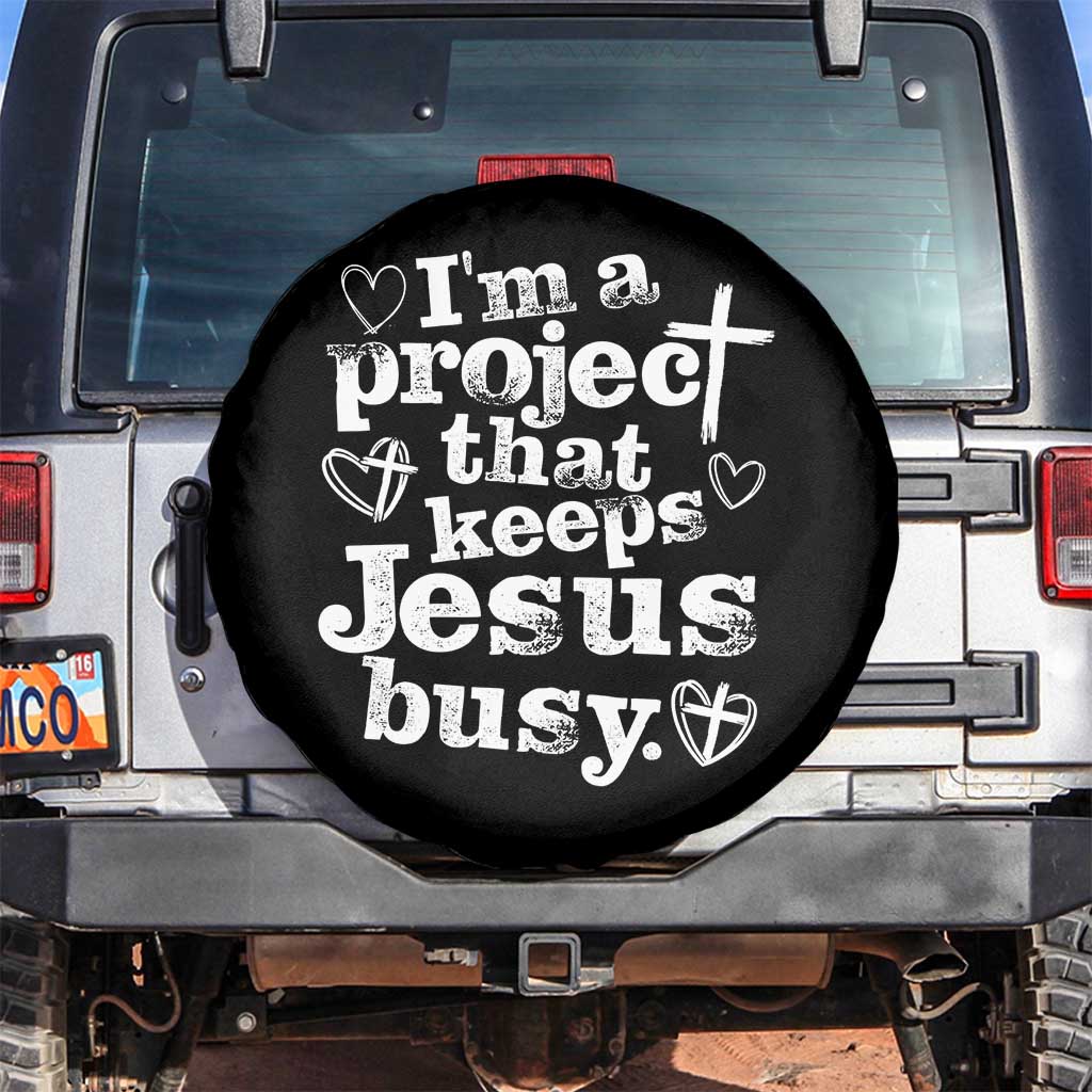 I am a Project That Keeps Jesus Busy Funny Christian Typography Spare Tire Cover Faith Humor Inspirational Gift TS02 No hole Black Print Your Wear