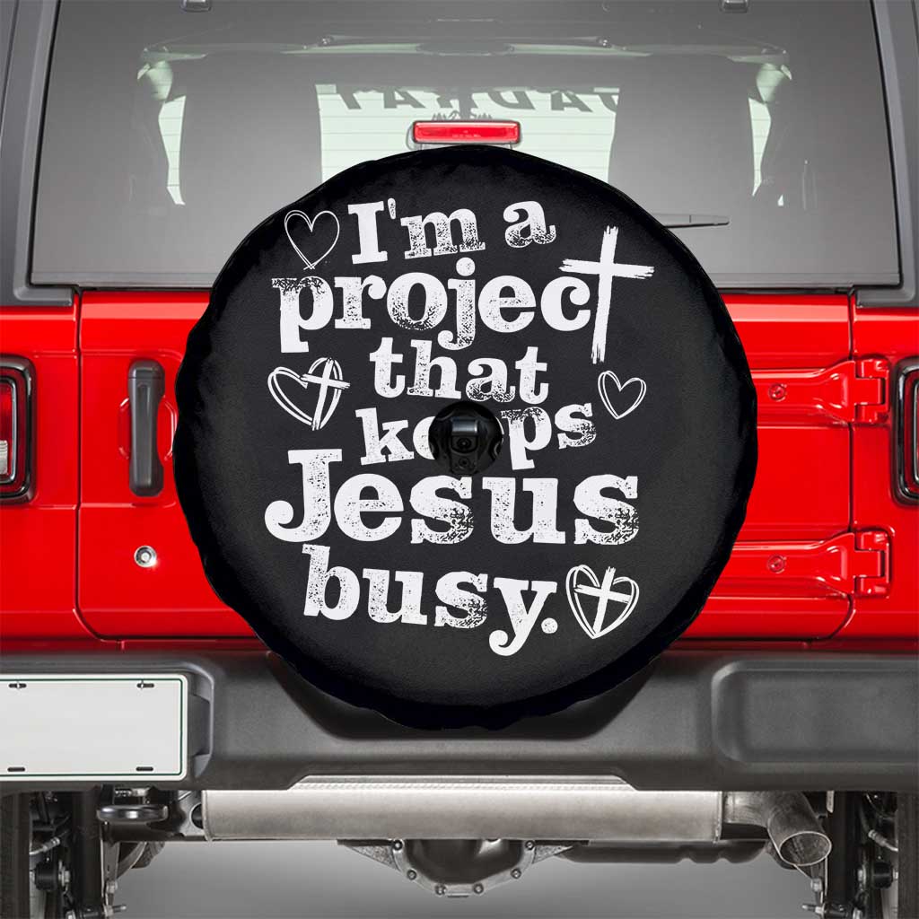 I am a Project That Keeps Jesus Busy Funny Christian Typography Spare Tire Cover Faith Humor Inspirational Gift TS02 Black Print Your Wear