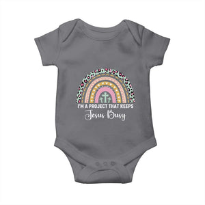 I am a Project That Keeps Jesus Busy Rainbow Cross Baby Onesie Cute Christian Faith Humor TS02 Charcoal Print Your Wear