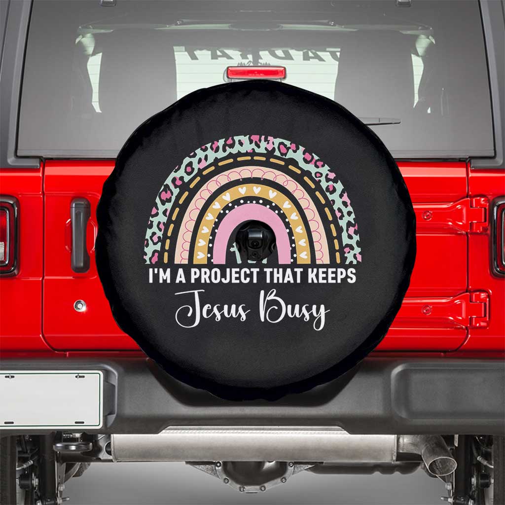 I am a Project That Keeps Jesus Busy Rainbow Cross Spare Tire Cover Cute Christian Faith Humor TS02 Black Print Your Wear