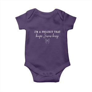 I am a Project That Keeps Jesus Busy Coquette Bow Baby Onesie Christian Faith Humor TS02 Purple Print Your Wear