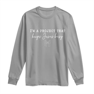 I am a Project That Keeps Jesus Busy Coquette Bow Long Sleeve Shirt Christian Faith Humor TS02 Sport Gray Print Your Wear