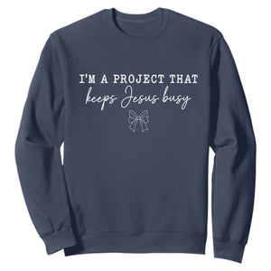 I am a Project That Keeps Jesus Busy Coquette Bow Sweatshirt Christian Faith Humor TS02 Navy Print Your Wear