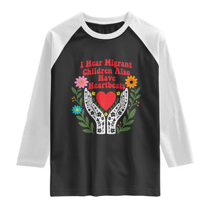 I Hear Migrant Children Also Have Heartbeats Raglan Shirt Groovy Retro Floral Hands Heart Social Justice