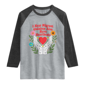 I Hear Migrant Children Also Have Heartbeats Raglan Shirt Groovy Retro Floral Hands Heart Social Justice