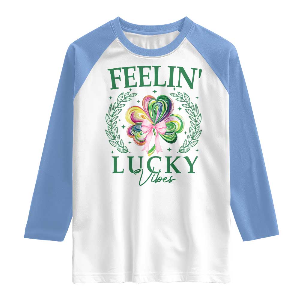 St. Patrick's Day Raglan Shirt Feelin' Lucky Vibes Shamrock Coquette Bow TS09 White Carolina Blue Print Your Wear