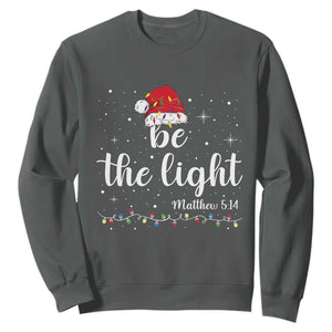 Be The Light Christmas Sweatshirt Christian Religious Bible Verse Santa Hat Pajama TS10 Dark Heather Print Your Wear