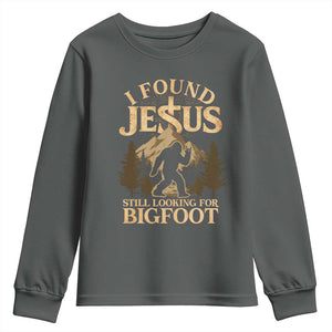 I Found Jesus Still Looking For Bigfoot Youth Sweatshirt Funny Christian Sasquatch Vintage Mountain TS11 Dark Heather Print Your Wear