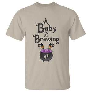 Funny Halloween Pregnancy Announcement T Shirt A Baby Is Brewing Witch Cauldron Footprint Pregnant Baby TS11 Sand Print Your Wear