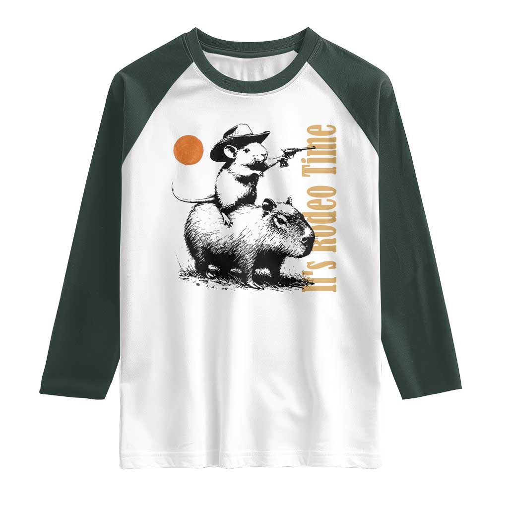 It Is Rodeo Time Raglan Shirt Funny Wild West Mouse Riding Capybara TS12 White Dark Forest Green Print Your Wear