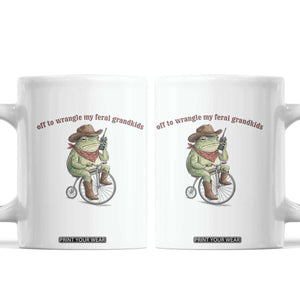Off to Wrangle My Feral Grandkids Coffee Mug Funny Cowboy Frog Grandpa Western Meme TS14 White Print Your Wear