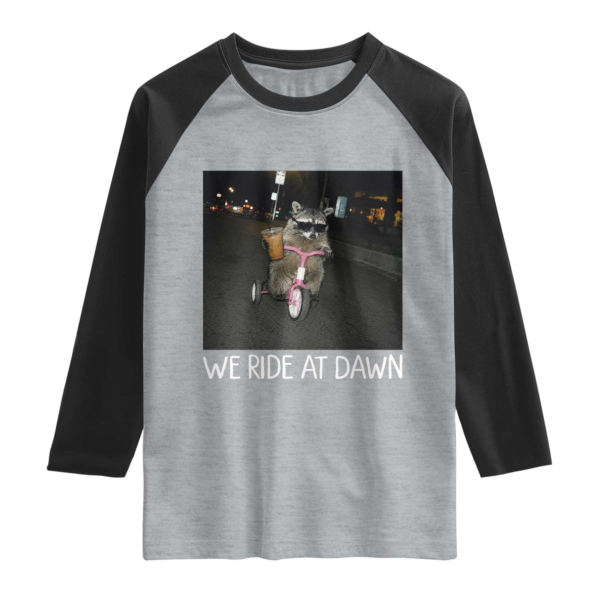We Ride at Dawn Raglan Shirt Funny Racoon Riding Tricycle Chaotic Meme