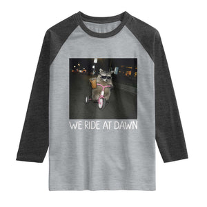 We Ride at Dawn Raglan Shirt Funny Racoon Riding Tricycle Chaotic Meme