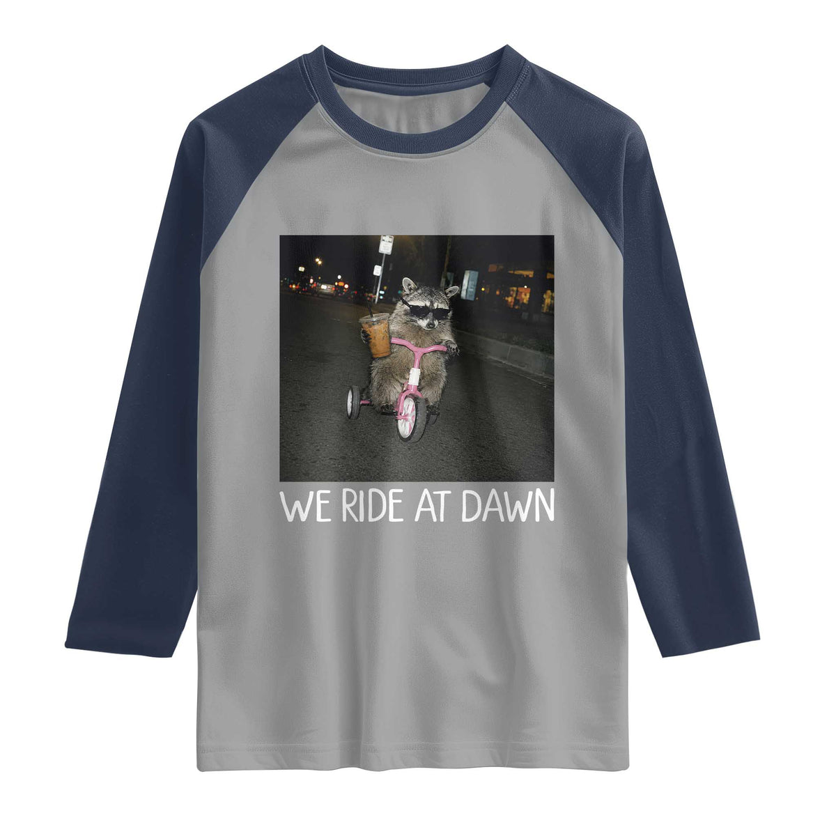 We Ride at Dawn Raglan Shirt Funny Racoon Riding Tricycle Chaotic Meme
