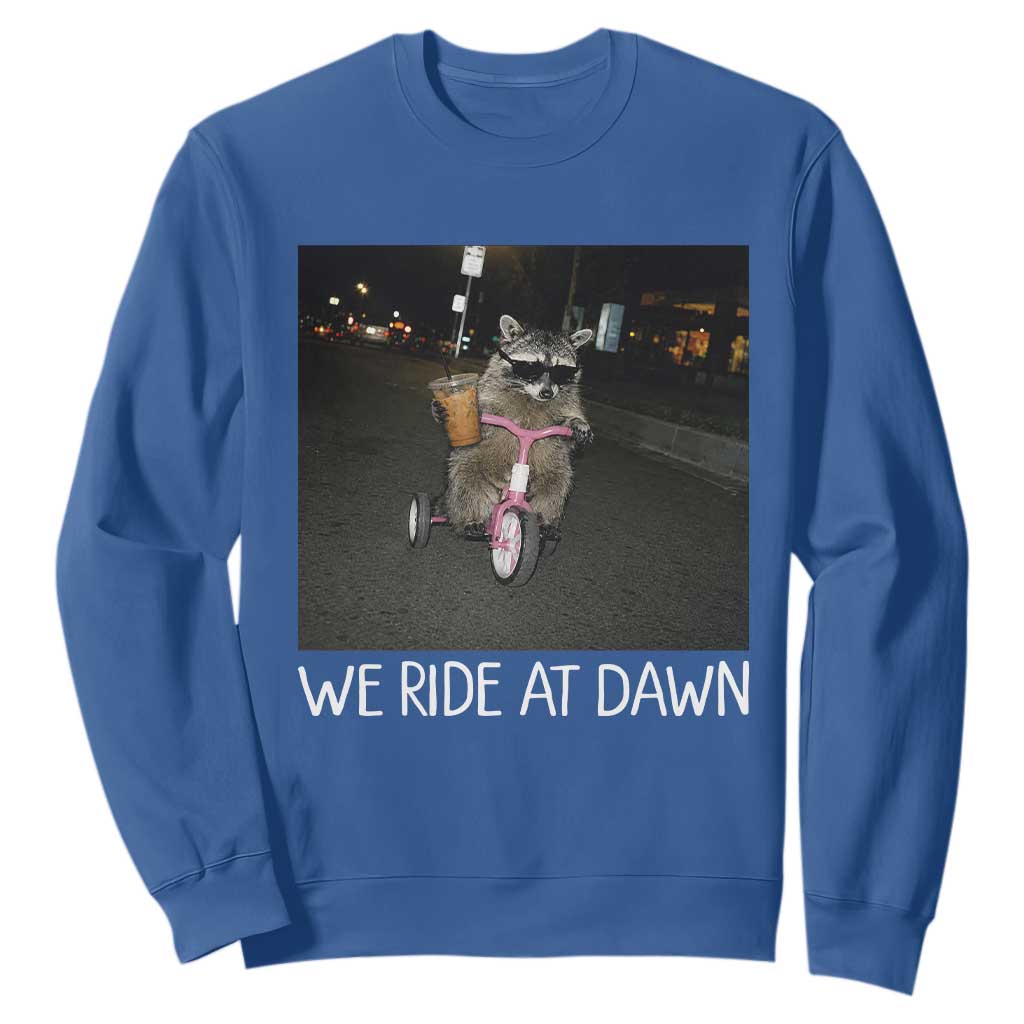 We Ride at Dawn Sweatshirt Funny Racoon Riding Tricycle Chaotic Meme