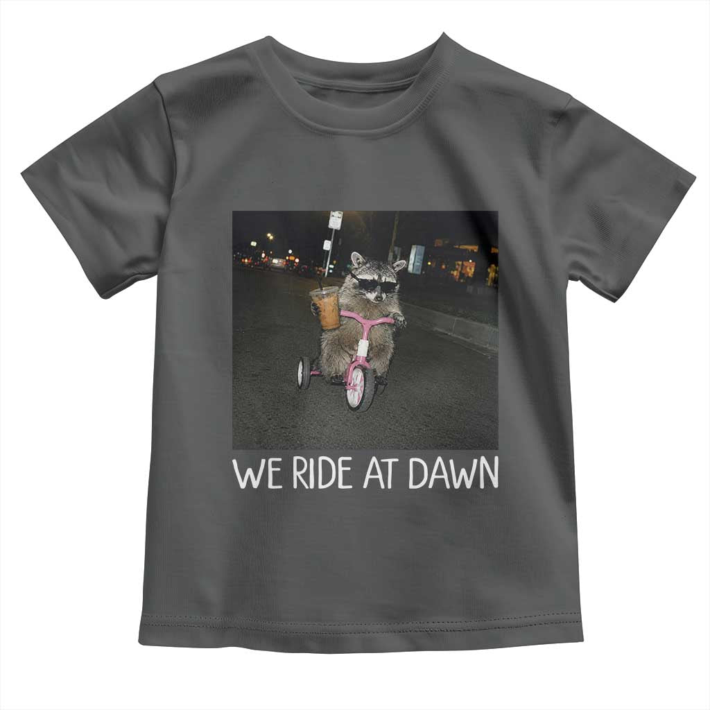 We Ride at Dawn Toddler T Shirt Funny Racoon Riding Tricycle Chaotic Meme