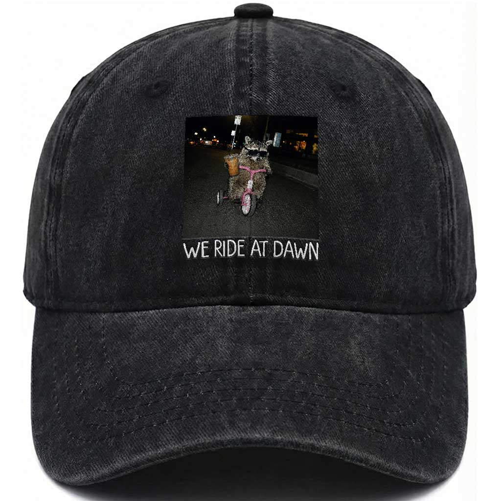 We Ride at Dawn Washed Cotton Baseball Cap Funny Racoon Riding Tricycle Chaotic Meme TS14 Print Your Wear